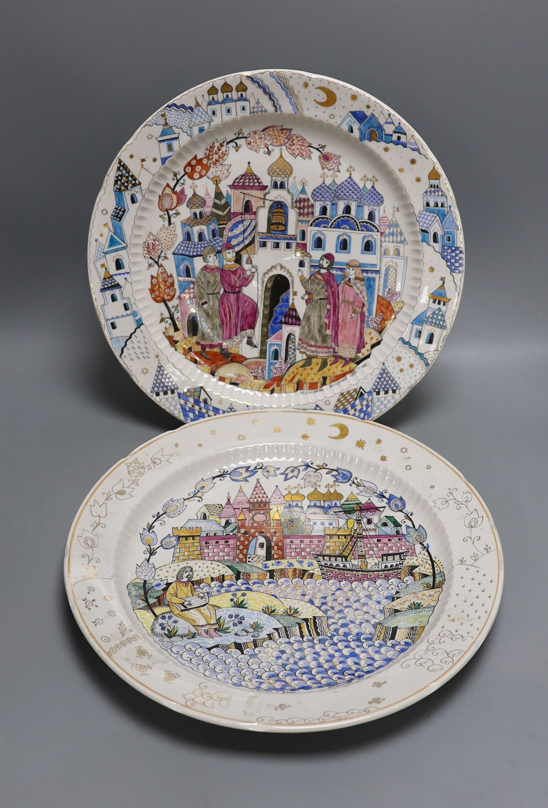 A pair of Russian porcelain dishes, painted by Malysheva and dated 1992, 35cm diameter